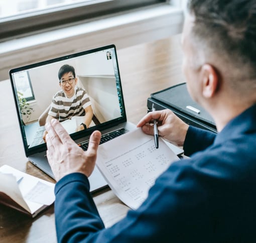 over the shoulder view of man in video call